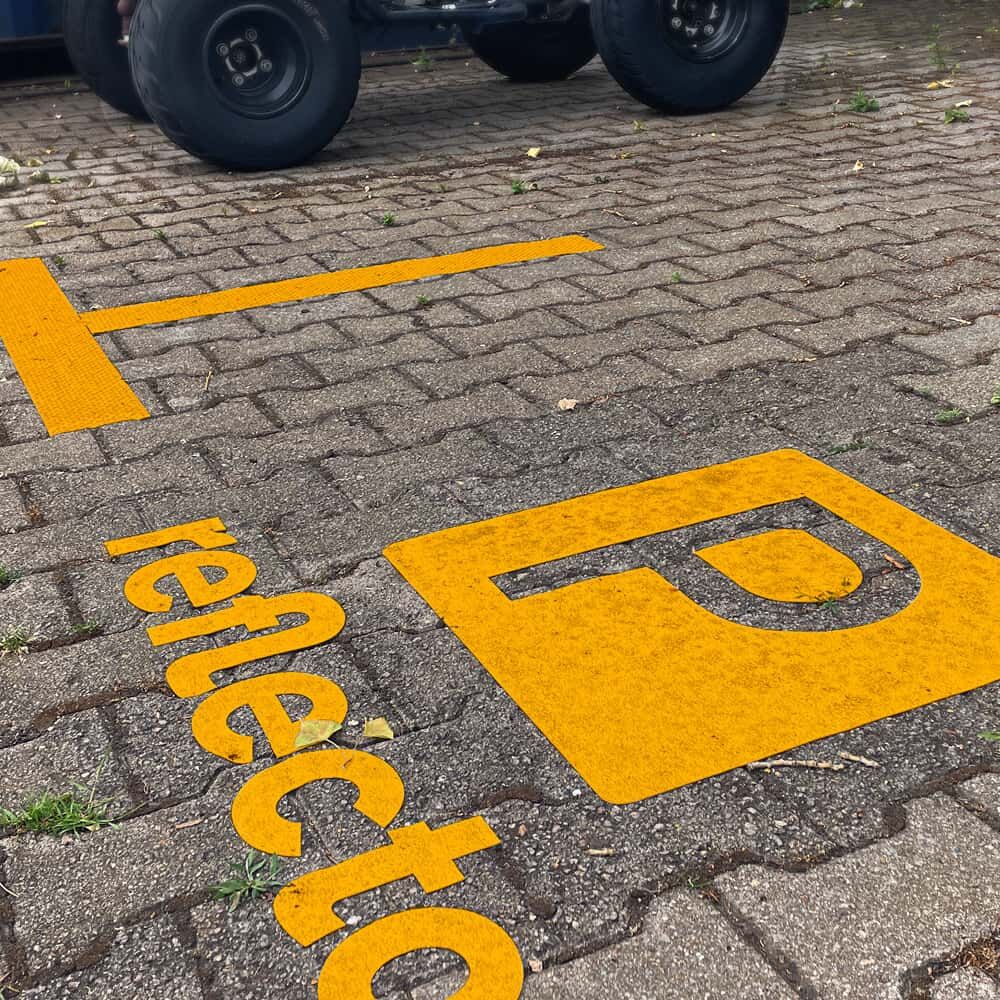 Gelbe 3M Stamark Parkplatzmarkierung „P reflecto“ auf Asphalt