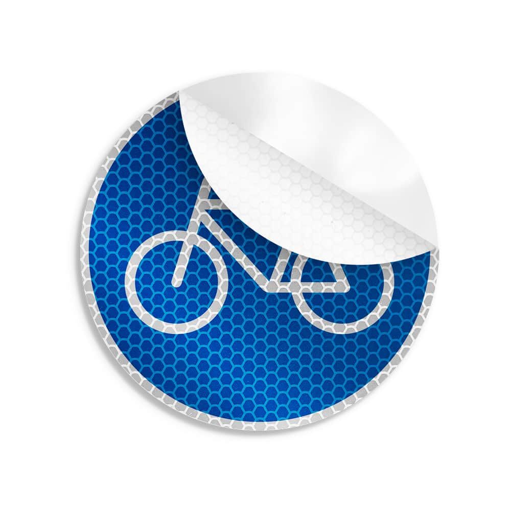 Teilweise abgelöster Radweg-Aufkleber mit reflektierendem Fahrrad-Symbol