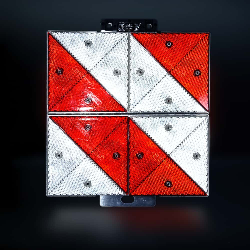 Parkwarntafel bei Dunkelheit: reflektierende rot/weiße Prismenfläche