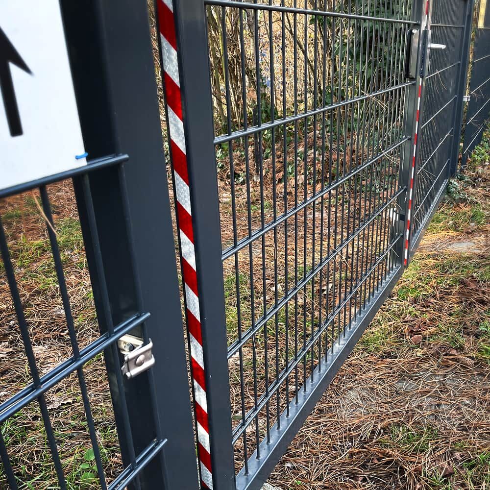Metalltor mit senkrechter 5931M rot-weiß Warnmarkierung beklebt