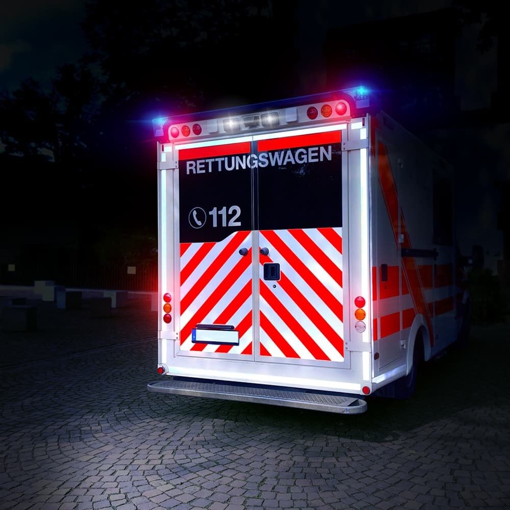 Nachts reflektierende Heckwarnmarkierung aus ORACAL Fluorfolie 7510, rot-weiß auf Rettungswagen