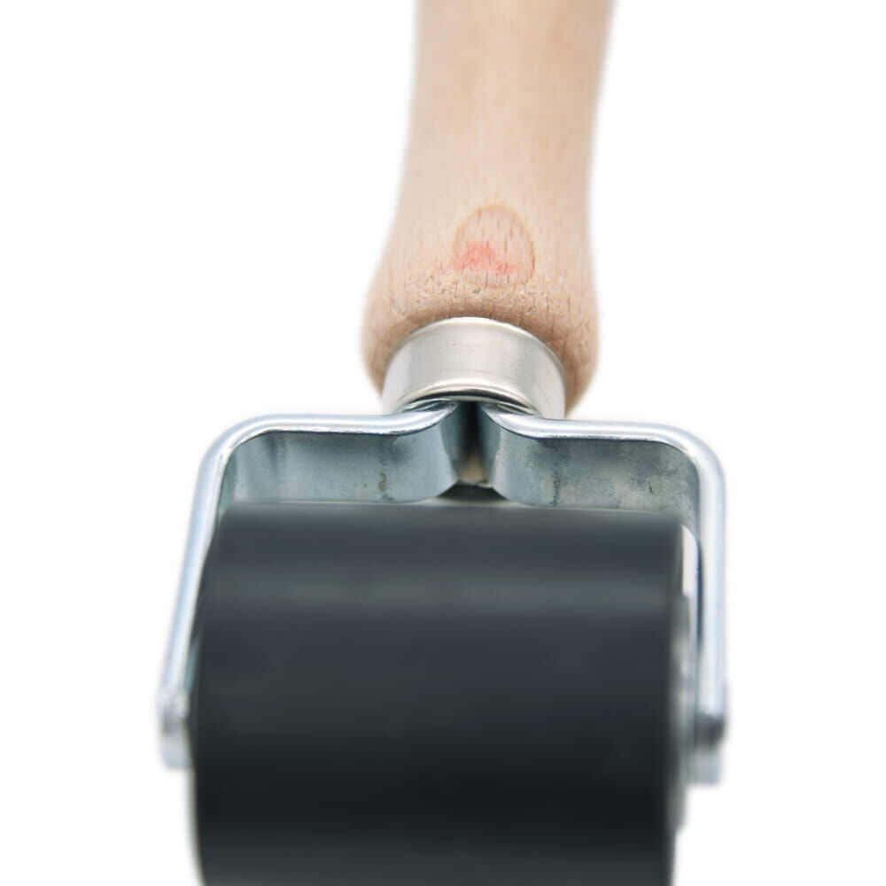 Nahaufnahme des Holzgriffs mit Fokus auf Übergang zur Walze